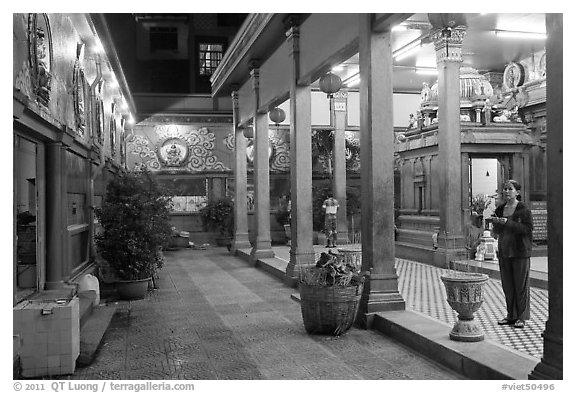 Woman in prayer, inside gallery, Mariamman Hindu Temple. Ho Chi Minh City, Vietnam (black and white)