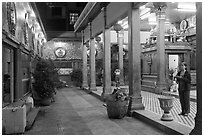 Woman in prayer, inside gallery, Mariamman Hindu Temple. Ho Chi Minh City, Vietnam (black and white)