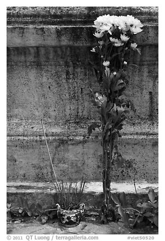 Incense and flowers next to tomb. Ben Tre, Vietnam