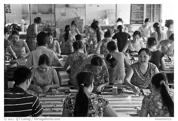 Women packing coconut candy in factory. Ben Tre, Vietnam (black and white)