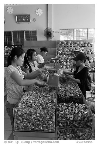 Women packing coconut candy for sale. Ben Tre, Vietnam