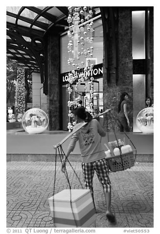 Food vendor and luxury store. Ho Chi Minh City, Vietnam (black and white)