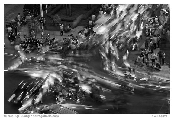 Long exposure traffic trails on busy intersection from above at night. Ho Chi Minh City, Vietnam (black and white)