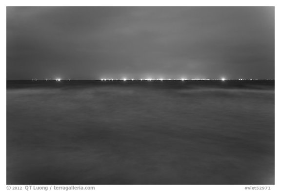 South China Sea at night with lights of fishing boats on horizon. Mui Ne, Vietnam