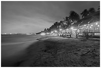 Beach bordered by resorts at night. Mui Ne, Vietnam (black and white)