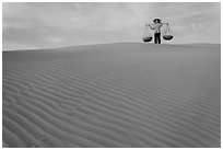 Woman on top of red sand dunes. Mui Ne, Vietnam (black and white)