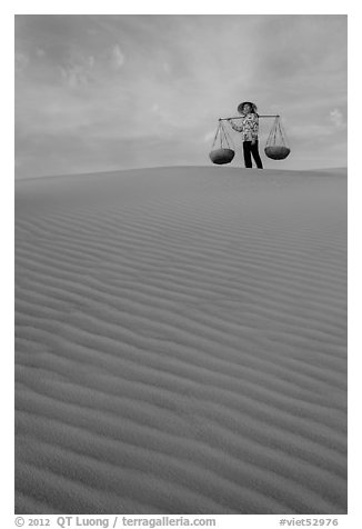 Woman on top of dune field. Mui Ne, Vietnam