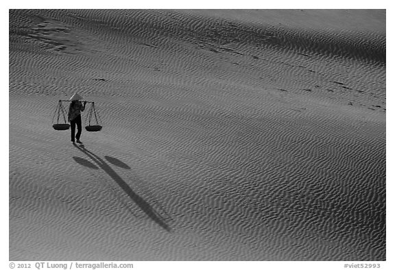 Shadows of woman on dune field. Mui Ne, Vietnam