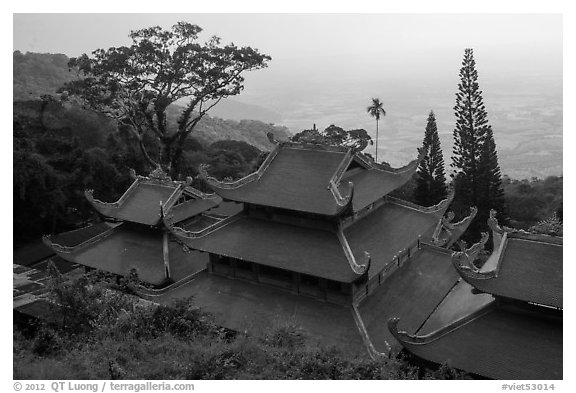 Temple rooftop overlooking plains in mist. Ta Cu Mountain, Vietnam (black and white)