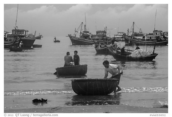 Fishermen on roundboats and fishing fleet. Mui Ne, Vietnam