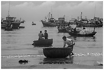 Fishermen on roundboats and fishing fleet. Mui Ne, Vietnam ( black and white)