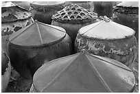 Amphorae for storage of traditional Vietnamese fish sauce Nuoc Mam. Mui Ne, Vietnam (black and white)