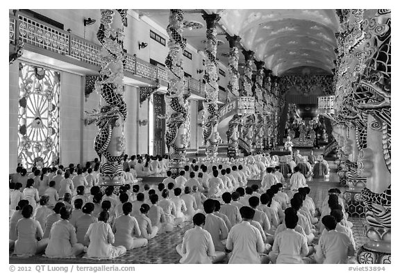 Rows of worshippers in Great Temple of Cao Dai. Tay Ninh, Vietnam (black and white)