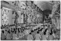 Rows of worshippers in Great Temple of Cao Dai. Tay Ninh, Vietnam ( black and white)