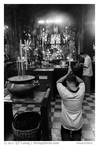 Worshippers inside Jade Emperor Pagoda. Ho Chi Minh City, Vietnam (black and white)