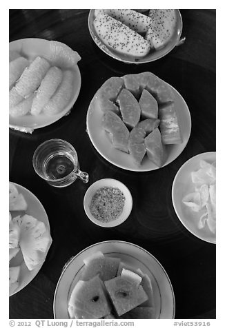 Fresh fruit quartered and served on table, Phoenix Island. My Tho, Vietnam (black and white)