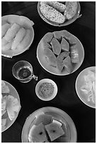 Fresh fruit quartered and served on table, Phoenix Island. My Tho, Vietnam (black and white)