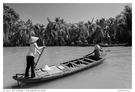 Women row canoes, Phoenix Island. My Tho, Vietnam (black and white)