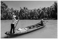 Women row canoes, Phoenix Island. My Tho, Vietnam (black and white)