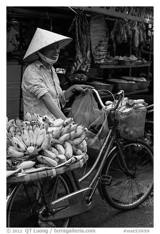 Woman selling bananas from bicycle. Ho Chi Minh City, Vietnam (black and white)