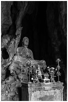 Altar and Buddha statue in grotto. Da Nang, Vietnam (black and white)