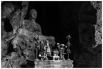 Altar and Buddha statue in cave. Da Nang, Vietnam (black and white)