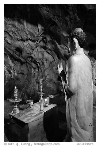Buddha statue in narrow cave, Marble Mountains. Da Nang, Vietnam