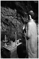 Buddha statue in narrow cave, Marble Mountains. Da Nang, Vietnam (black and white)