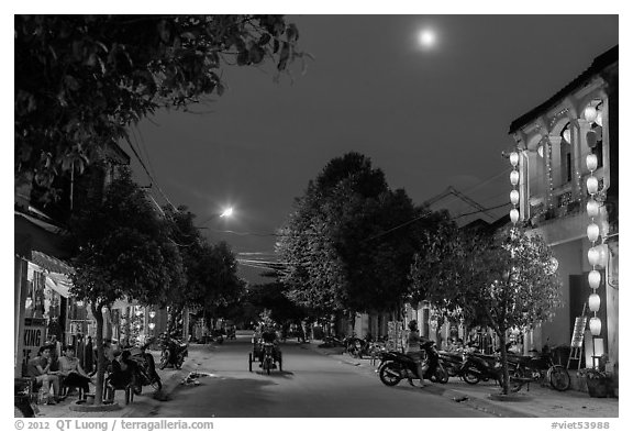 Street at dusk with moon and lanterns. Hoi An, Vietnam