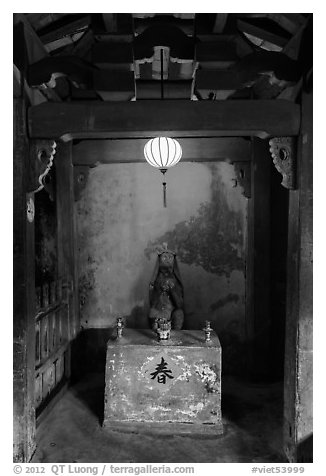 Monkey altar lit by lantern, Japanese Bridge. Hoi An, Vietnam