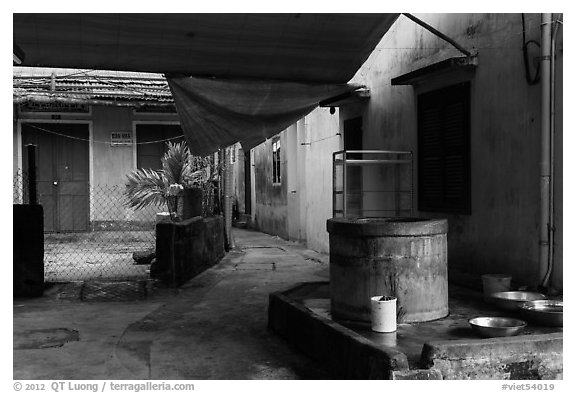 Well and alley. Hoi An, Vietnam