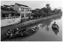 Waterfront with people selling from boats. Hoi An, Vietnam (black and white)