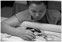 Woman working on a silk embroidery piece. Hoi An, Vietnam (black and white)