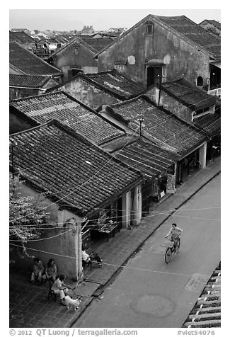 Elevated view of street with woman on bicycle. Hoi An, Vietnam (black and white)