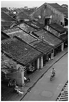 Elevated view of street with woman on bicycle. Hoi An, Vietnam ( black and white)