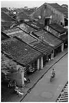 Elevated view of street with woman on bicycle. Hoi An, Vietnam (black and white)