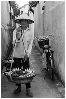 Fruit vendor carrying bananas. Hoi An, Vietnam ( black and white)