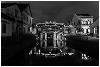 Japanese covered bridge reflected in canal at night. Hoi An, Vietnam (black and white)