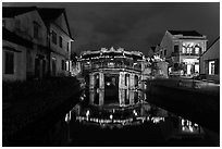 Japanese covered bridge reflected in canal at night. Hoi An, Vietnam ( black and white)