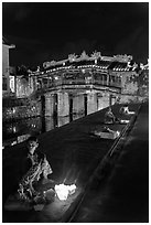 Candle vendors in front of Japanese bridge at night. Hoi An, Vietnam ( black and white)