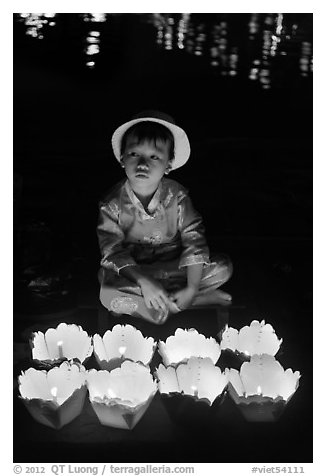 Boy with candle lanterns for sale. Hoi An, Vietnam (black and white)