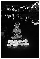 Boy selling candle lanterns by the river. Hoi An, Vietnam (black and white)