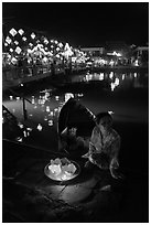 Woman selling candle lanterns by the bridge. Hoi An, Vietnam (black and white)