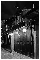 Townhouse with wooden doors lighted by paper lanterns. Hoi An, Vietnam (black and white)