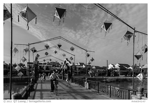 Schoolchildren cross Cam Nam bridge. Hoi An, Vietnam (black and white)