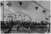 Schoolchildren cross Cam Nam bridge. Hoi An, Vietnam (black and white)