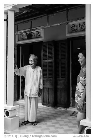Woman and elder on porch of their house, Cam Kim Village. Hoi An, Vietnam (black and white)
