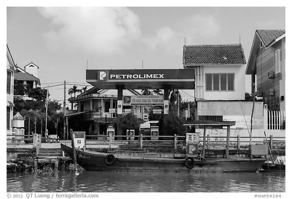 Road and river petrol station. Hoi An, Vietnam (black and white)