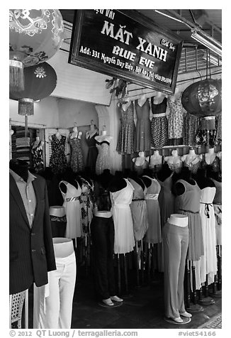 Colorful outfits and lanterns in textile shop. Hoi An, Vietnam