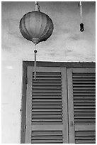 Paper lantern, wall, and blue shutters. Hoi An, Vietnam (black and white)